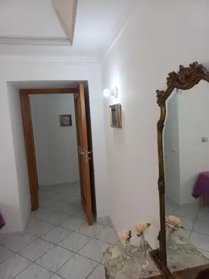 a white room with a mirror and a door at Al Palazzo Del Principe al Massimo in Palermo