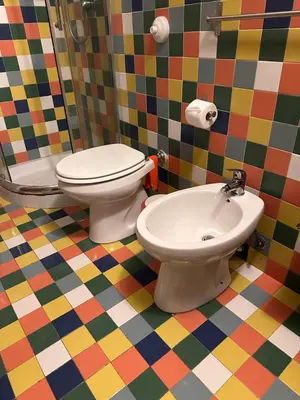 a bathroom with a toilet and a sink at BLU Fronte Mare in Palermo
