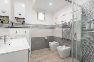 a bathroom with a toilet and a sink and a shower at Orleans Apartment in Palermo