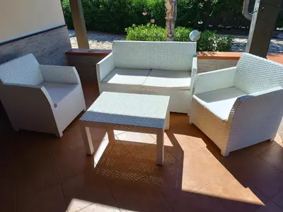 a group of chairs and a table on a patio at Castellaccio Scopello Villetta con piscina in Scopello
