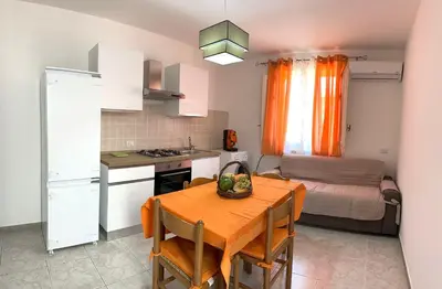 a kitchen and dining room with a table and a bed at Billy Home in Villabate