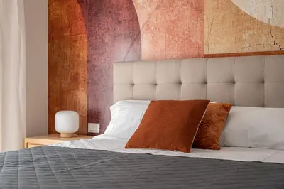 a bedroom with a bed with a large headboard at Le perle del capo in Palermo
