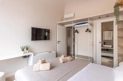 a bedroom with a bed with two teddy bears on it at Le perle del capo in Palermo