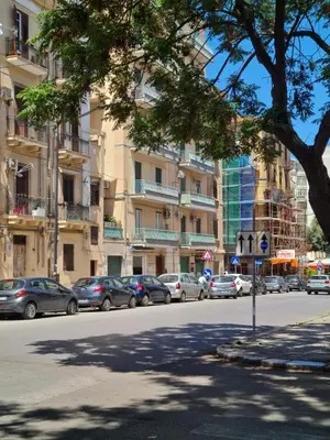 a street with cars parked on the side of the road at La dimora di Elma in Palermo