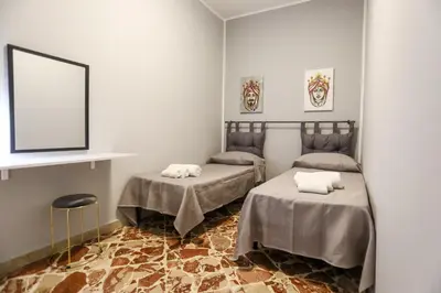 a room with two beds and a mirror at Medea Suite Panoramic in Palermo
