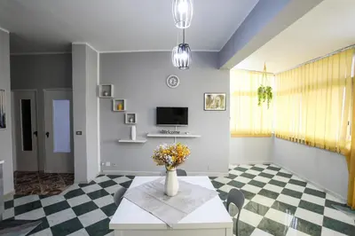 a living room with a vase of flowers on a table at Medea Suite Panoramic in Palermo