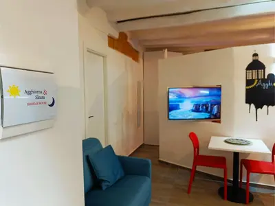 a living room with a blue couch and a table at Agghiorna&skura 2,0 in Palermo