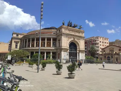 a large building with potted plants in front of it at Casa varco Santa Lucia in Palermo