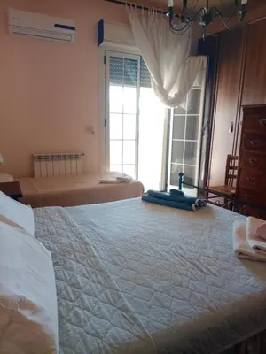 a bedroom with a large bed with a large window at Terrazza Mare Mondello in Palermo