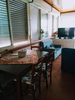 a living room with a table and a couch at Terrazza Mare Mondello in Palermo