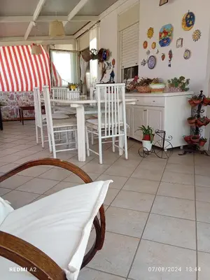 a kitchen with a table and chairs in a room at Terrazza Mare Mondello in Palermo