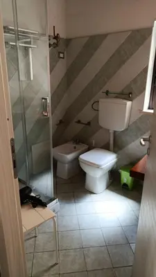 a bathroom with a toilet and a shower at Domus Case Vacanze civico del mare in Castellammare del Golfo