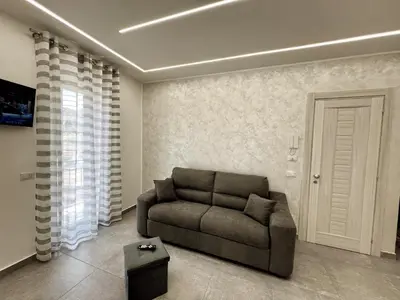a living room with a couch and a table at Flowers Apartments in Marineo