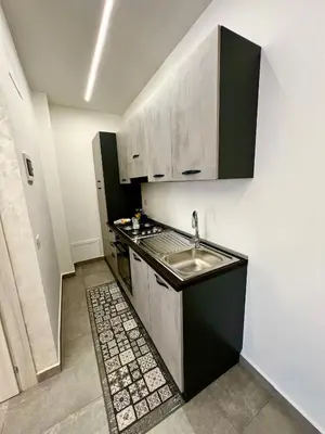 a small kitchen with a sink and a stove at Flowers Apartments in Marineo