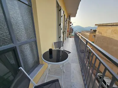 a balcony with a table and chairs on a balcony at Flowers Apartments in Marineo