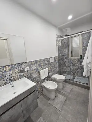 a bathroom with a sink and a toilet and a tub at Flowers Apartments in Marineo
