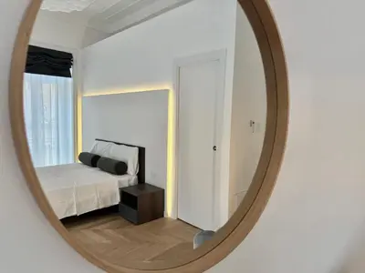 a bedroom with a bed and a mirror at Casa O'Tama in Palermo