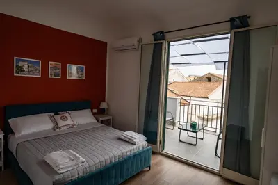 a bedroom with a bed and a sliding glass door at Molinari Palermo in Palermo