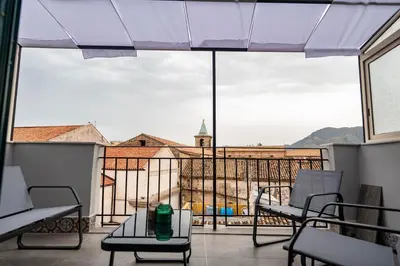 a balcony with chairs and a view of a church at Molinari Palermo in Palermo