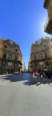 two people standing in the middle of a street at Crihouse in Palermo
