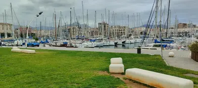 a grassy area with boats in a marina at Crihouse in Palermo
