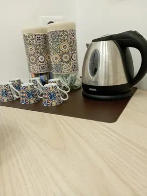 a toaster and coffee cups sitting on a shelf at Archimede Rooms in Palermo