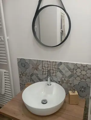 a bathroom with a white sink and a mirror at Archimede Rooms in Palermo