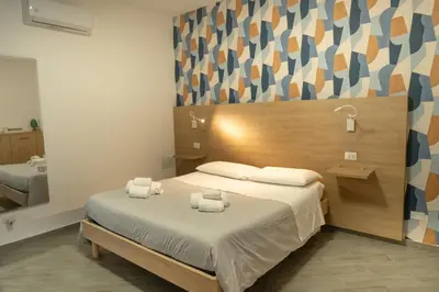 a bedroom with a bed with towels on it at Appartamento completo con parcheggio privato - Villa Ciaculli in Villabate