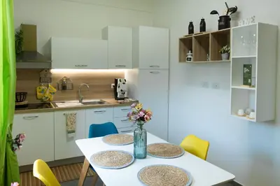 a kitchen with a table with two plates on it at Appartamento completo con parcheggio privato - Villa Ciaculli in Villabate