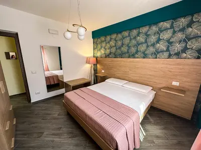 a hotel room with a bed and a mirror at Intero Appartamento con Terrazza - Villa Ciaculli in Palermo
