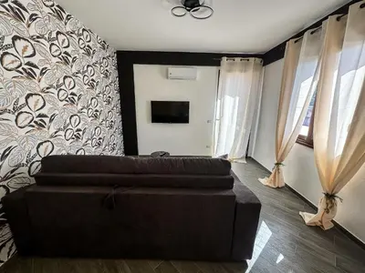 a living room with a couch and a tv at Intero Appartamento con Terrazza - Villa Ciaculli in Palermo