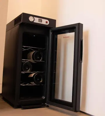 a black refrigerator with its door open next to a wall at Nothotel delle Rose in Palermo