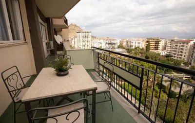 a balcony with a table and chairs and a view at Nothotel delle Rose in Palermo