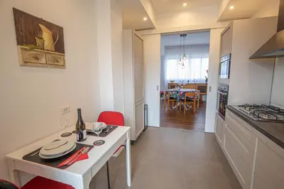 a kitchen and living room with a table and chairs at Nothotel delle Rose in Palermo