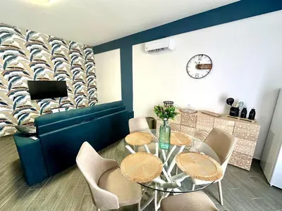 a dining room with a table and chairs and a clock at Intero Appartamento con Solarium - Villa Ciaculli in Palermo