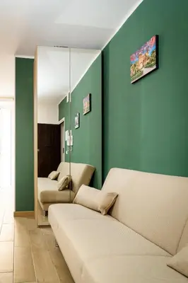 a living room with two beds and a mirror at DIMORA SAITTA per SAITTA HOLIDAYS in Palermo