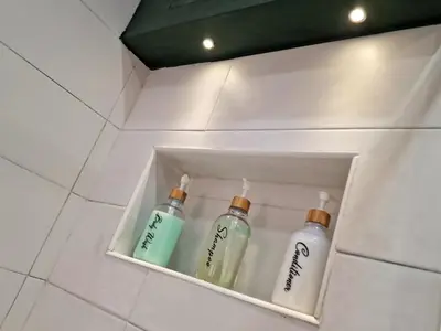 two bottles of soap in a niche in a bathroom at DIMORA SAITTA per SAITTA HOLIDAYS in Palermo