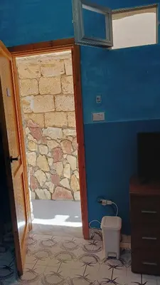 a door to a room with a stone wall at LA TERRAZZA SUL MARE camera doppia vicino aereoporto&mare SICILIAN SEA STYLE ROOM in Cinisi