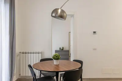 a dining room with a wooden table and chairs at La casa sul Mercato by Wonderful Italy in Palermo