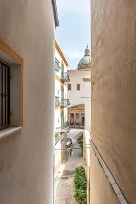 a view from an alley between two buildings at La casa sul Mercato by Wonderful Italy in Palermo