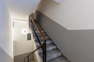 a staircase in a house with a white wall at Piazza Marina Suite By DomuSicily in Palermo