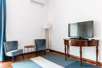 a room with a tv on a table with two chairs at Piazza Marina Suite By DomuSicily in Palermo