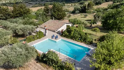 an aerial view of a villa with a swimming pool at La Gurra Tenuta Migliore By DomuSicily in Chiusa Sclafani