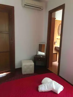 a bedroom with a bed and a mirror and a tv at Little house of Grandpa Antonio in Palermo