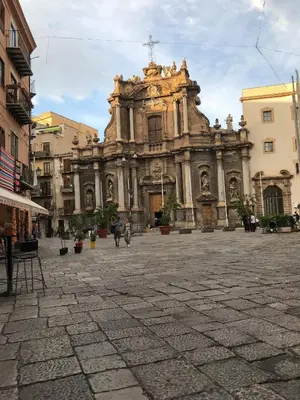 an old building in a plaza in a city at Little house of Grandpa Antonio in Palermo