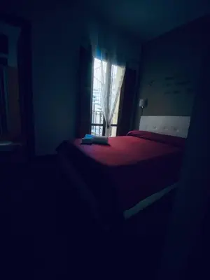 a dark room with a bed and a window at Little house of Grandpa Antonio in Palermo