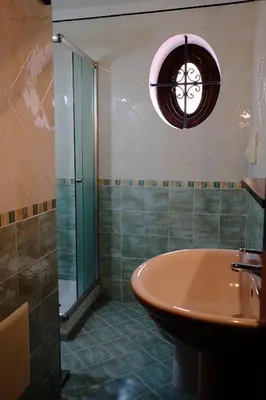 a bathroom with a sink and a tub and a window at Maison al Massimo - City Center Full Apartment in Palermo
