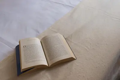 an open book sitting on top of a bed at Maison al Massimo - City Center Full Apartment in Palermo