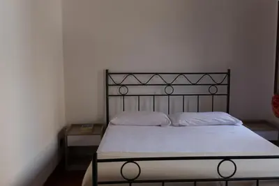 a bedroom with a bed with a metal headboard at Maison al Massimo - City Center Full Apartment in Palermo