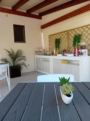 a kitchen with a table with a plant on it at Olea in Castelluzzo